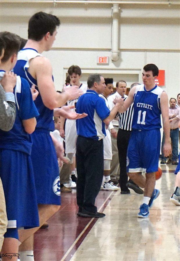 Senior Joe Mauceri is met by Coach Poirier and his teammates as he heads to the bench. Photo courtesy of William Gantt.