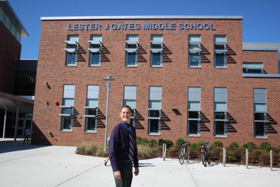 Mr. Ryan Beattie stands in front of the new Gates Middle School, where he serves as Assistant Principal.