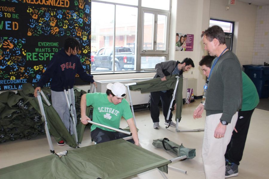 Students and SHS teacher Brad Mingles start to set up the community storm shelter in the SHS cafeteria. Photo Courtesy of Lauren Montgomery