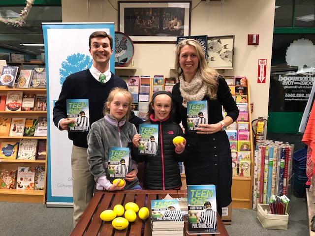 Phil Struzziero with his family during a book signing event at Buttonwood Books & Toys 