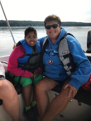 Kim Woodford enjoys a boat ride with one of her favorite campers