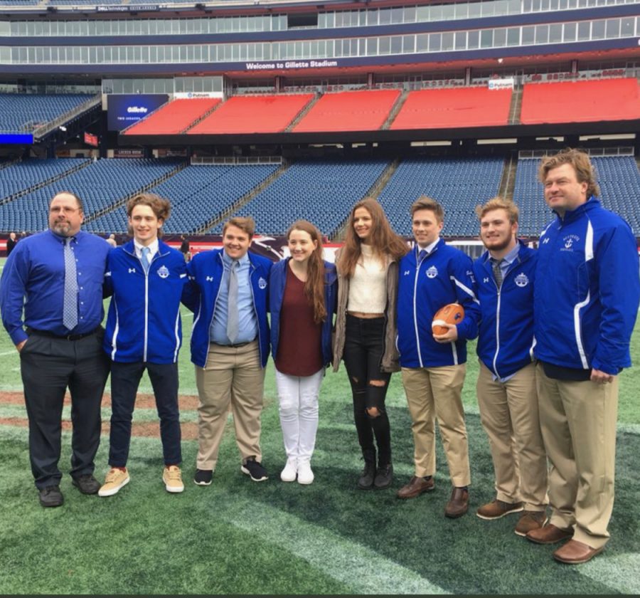 On the field. From left, Vice Principal Bill Luette, Captain Daniel May, Captain Josh Comeau, Cheer Captain Hannah Jordan, Cheer Captain Julia Babb, Captain Aidan Sullivan, Captain Josh McKeever, and Head Coach Herb Devine