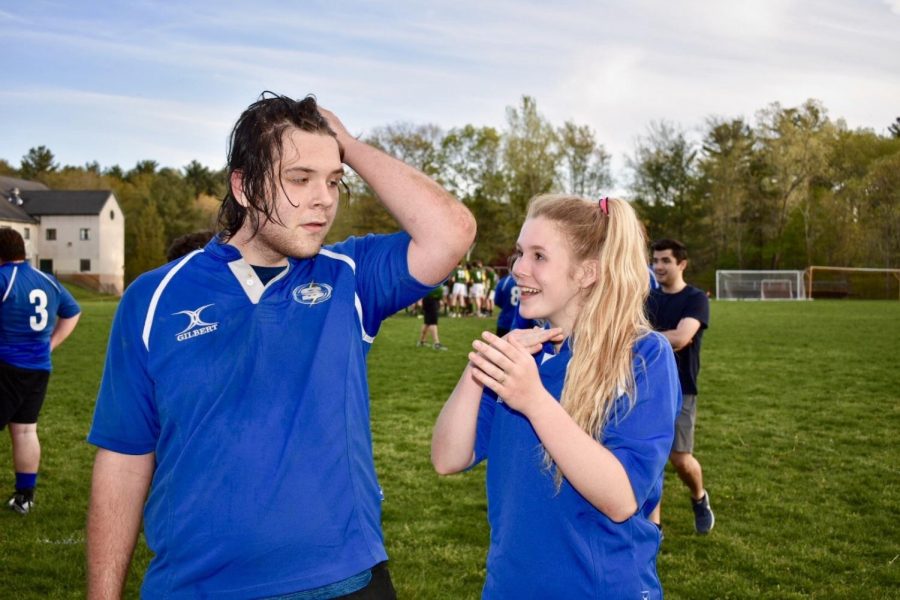 Sophomore Anja Soltesz on the rugby field with her brother