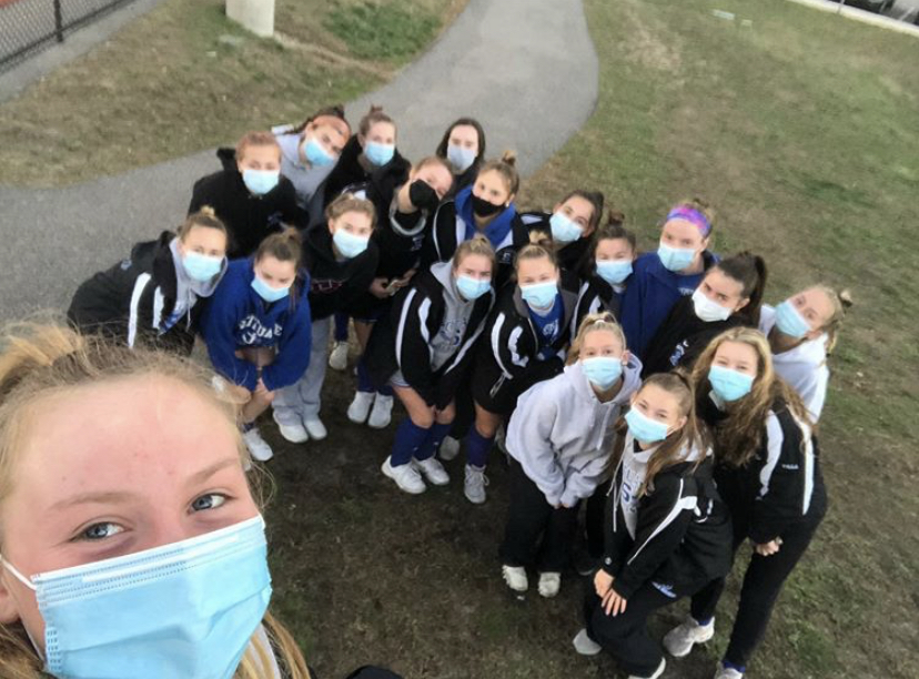 Varsity field hockey captain Sarah Irish takes a selfie with her teammates.