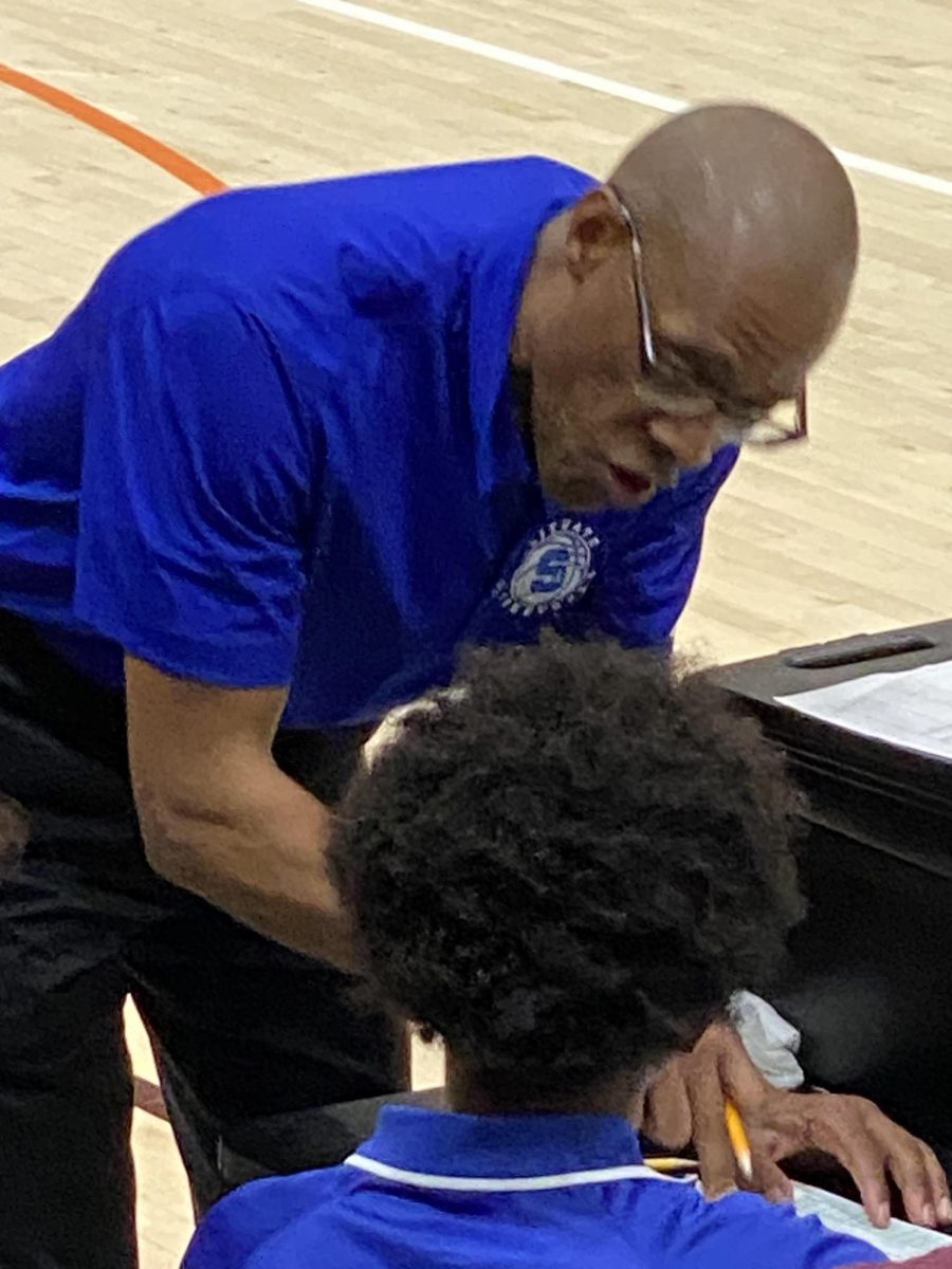 Coach Jordan confers with SHS senior Dawit Quilty during the March 9th tournament game against Sharon