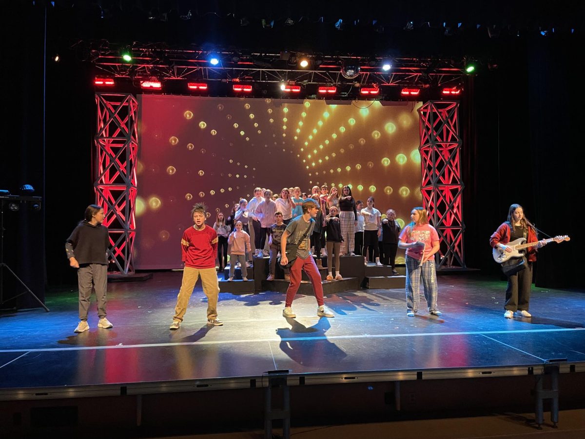 Gates Middle School students rehearse during tech week for "We Will Rock You"