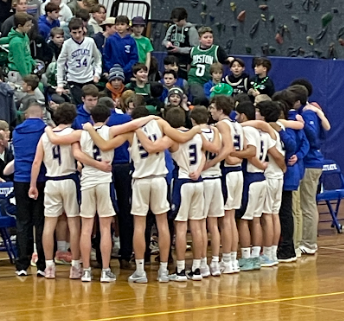 A Scituate Sailor huddle with Coach Matt Poirier at the helm. 