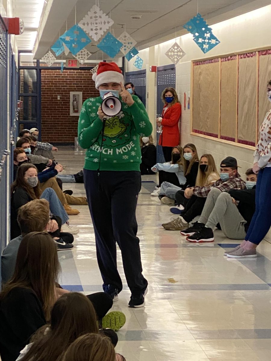 Kevin+entertained+students+and+staff+each+year+with+his+unique+rendition+of+the+Grinch.+In+2020%2C+students+gathered+together+in+the+hallway+while+Kevin+performed.